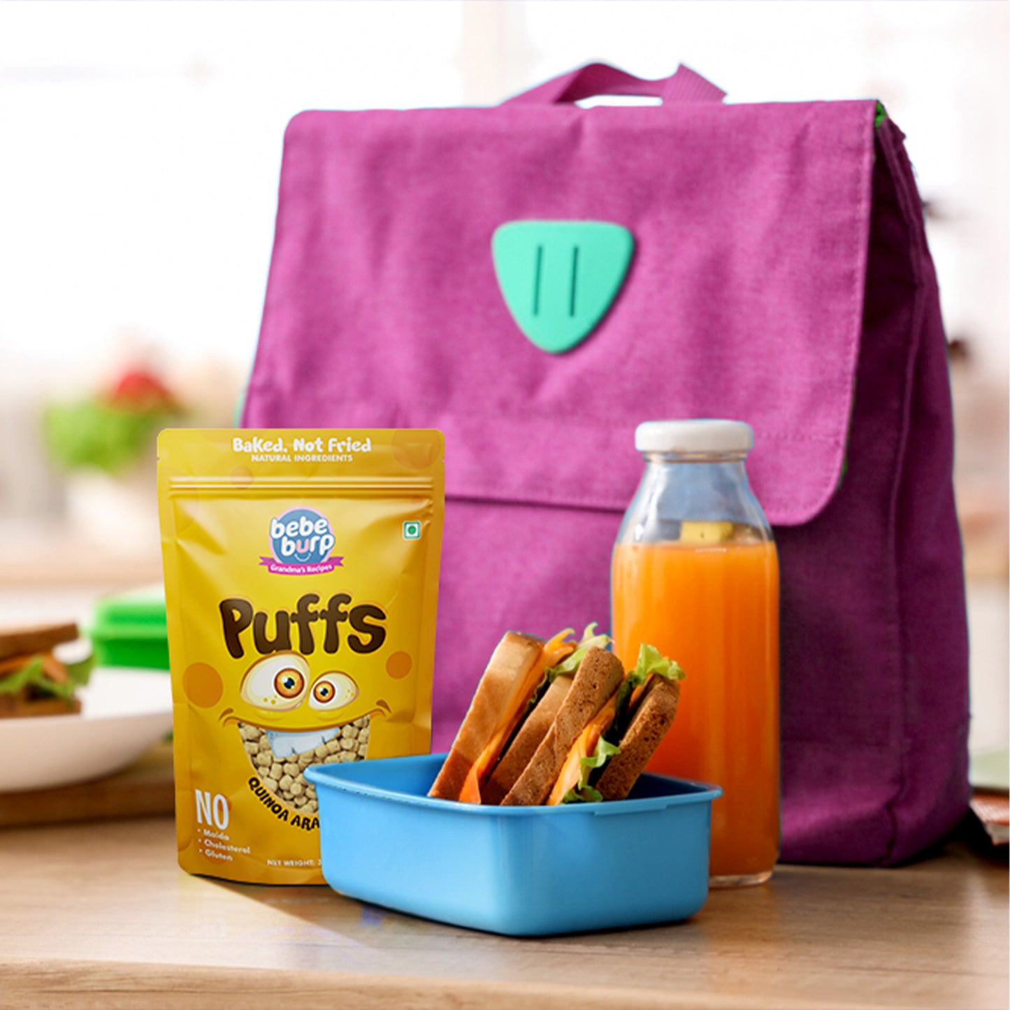 Four packs of Bebe Burp quinoa Arabic herbs puff for baby, with oats, quinoa, garlic, and millet displayed in front.