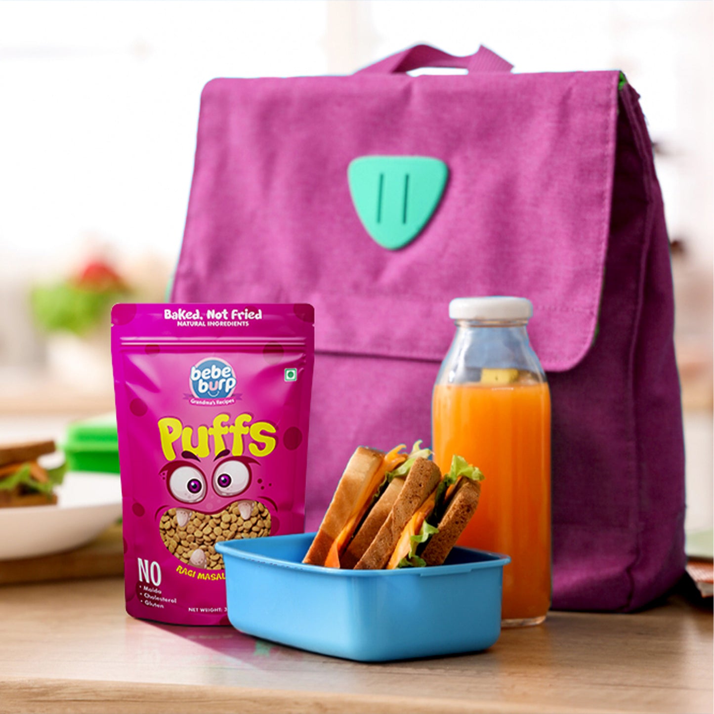 Bebe Burp Ragi Masala Masti baby puffs made with natural ingredients, shown with grains and spices in the front.