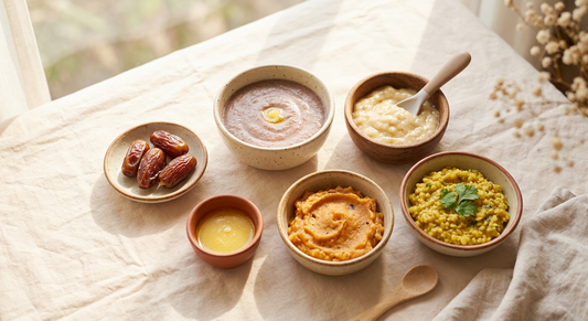 Indian baby weight gain foods — ragi porridge, banana, dates, ghee and khichdi in small bowls.