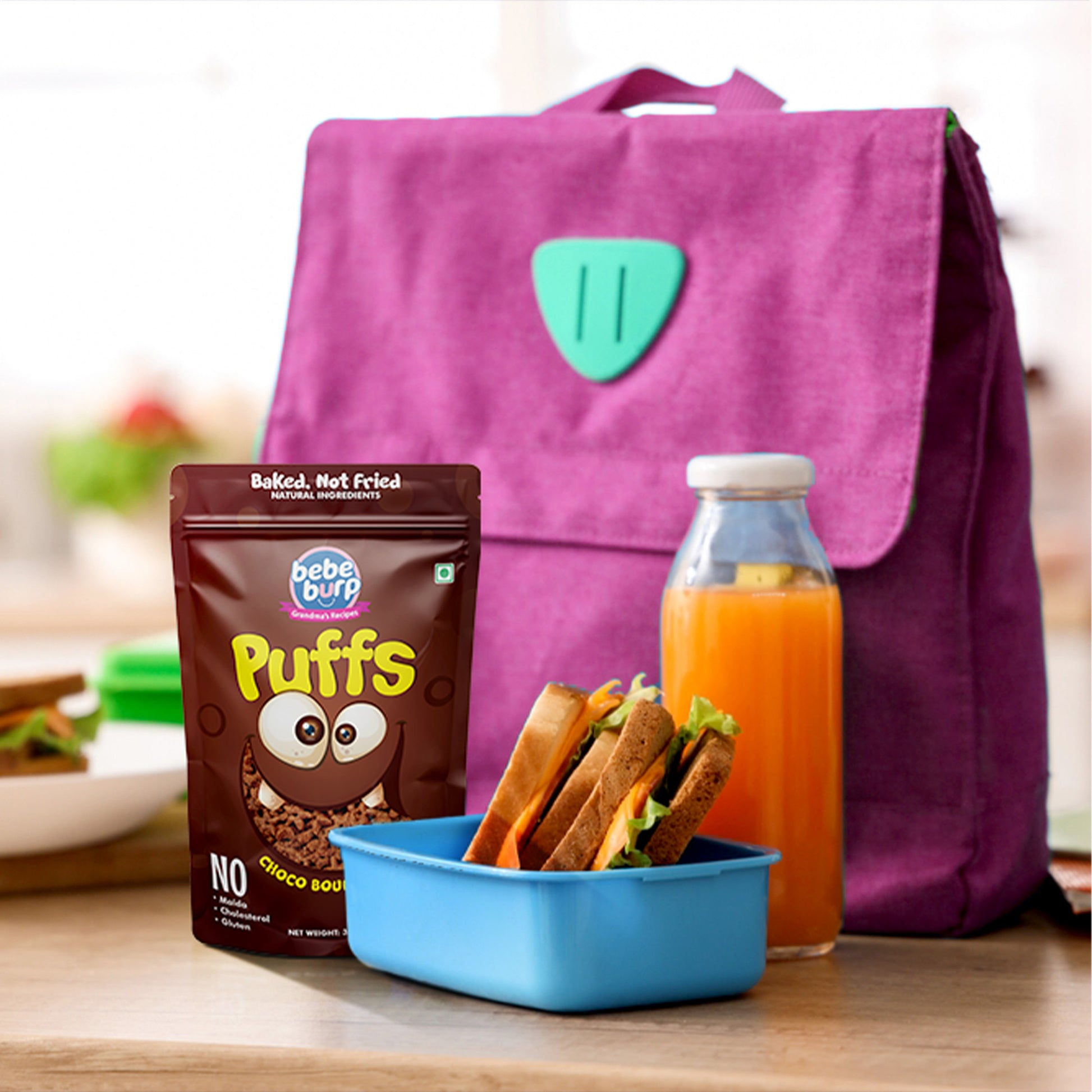 Four packs of Bebe Burp Choco Bounce puff for baby, made with ragi, jowar, jaggery, and chocolate curls in front.